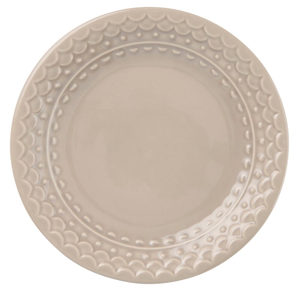 Asjett Nora 20 cm Beige, en rund beige asjett med bølget kant og prikkete bord.