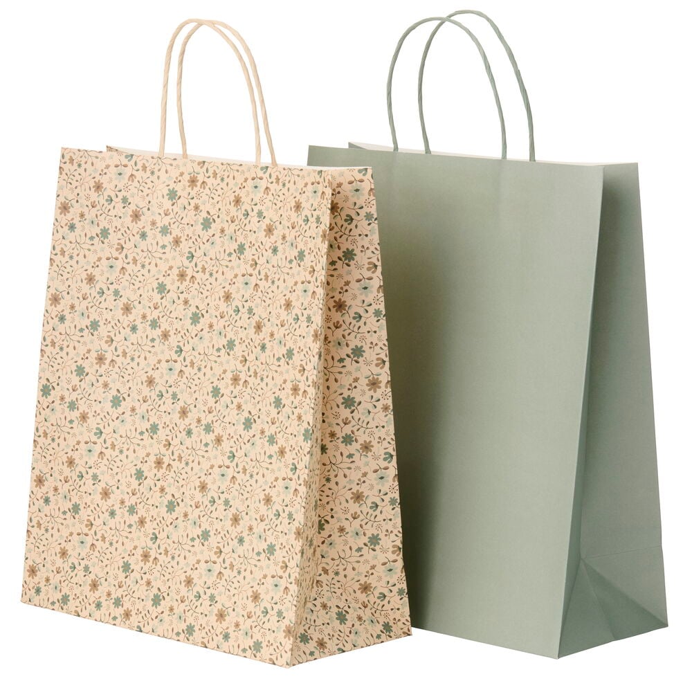 Två Presentpåsar; en mönstrad beige med gröna/bruna blommor och en enfärgad salviagrön, båda med snörhandtag.