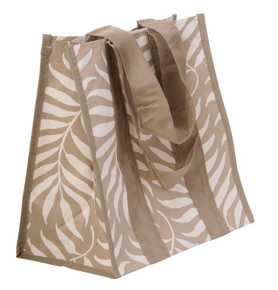 Beige lounaslaukku, jossa valkoinen lehtimäinen kuvio.