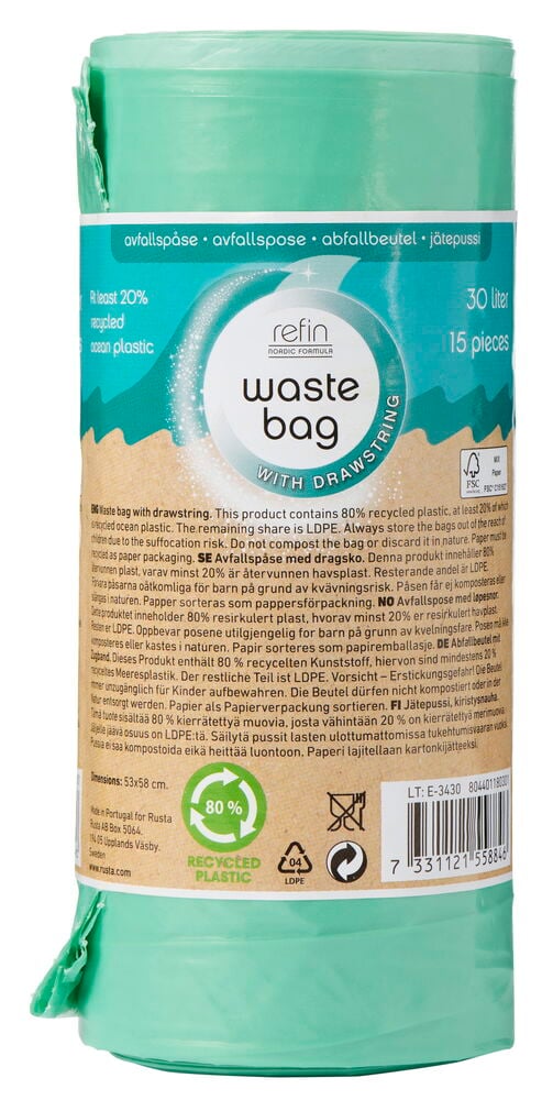 Grön rulle med avfallspåsar och brun etikett.