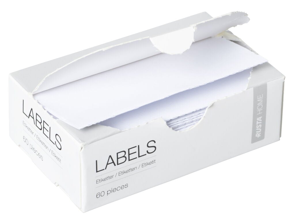 Valkoinen kartonkilaatikko, jossa on neliönmuotoiset valkoiset etiketit.