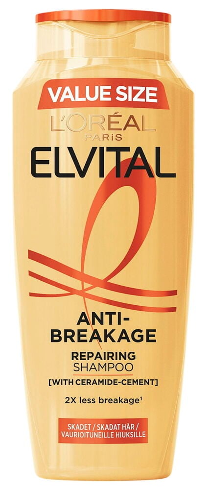 En orange schampoflaska med röd och svart text.