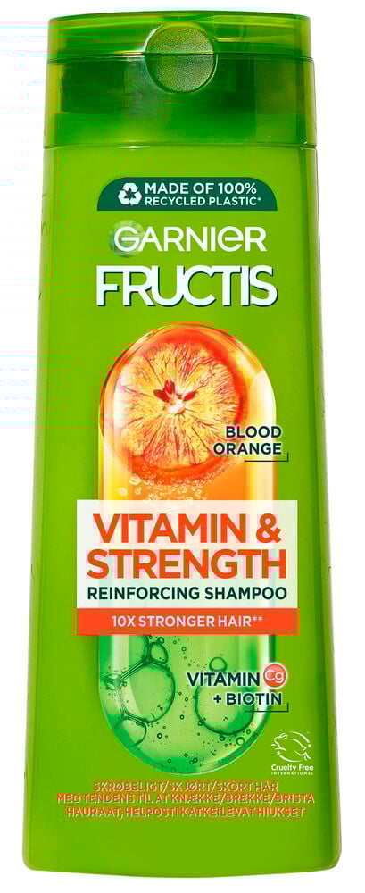 Grön schampoflaska med apelsinmotiv på etiketten.