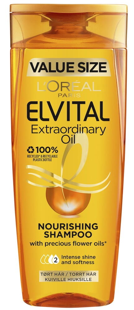 Orange schampoflaska med guldfärgad etikett och lock.