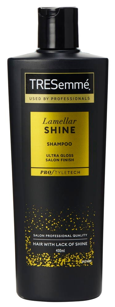 Musta shampoo-pullo, jossa on kultainen teksti, Tresemmé.