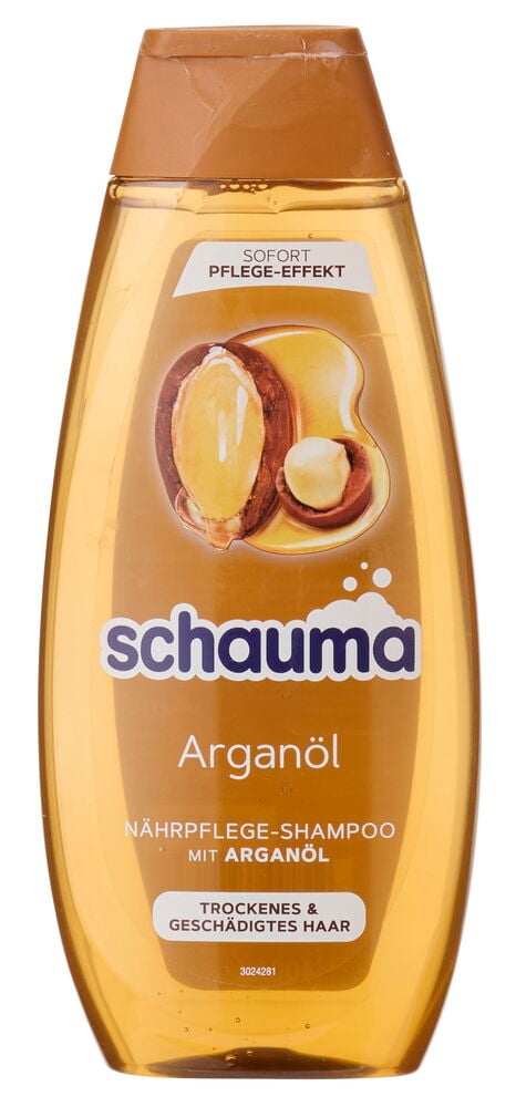 Eine goldene Schauma Arganöl Shampoo Flasche mit braunem Deckel und Argan Nuss Etikett.