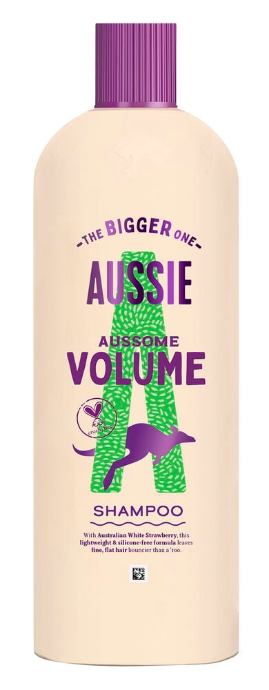 Sjampo Aussie 600 ml Volume flaske, kremfarget kropp, riflet lilla kork og grønn og lilla etikett.