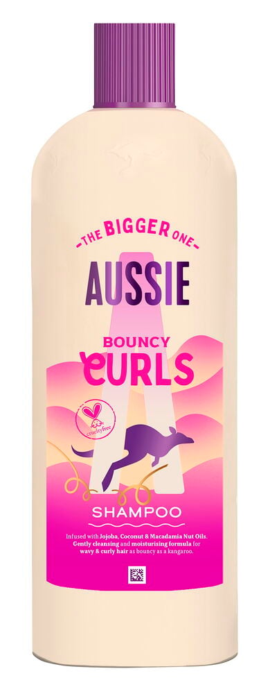 Sjampo Aussie 600 ml Curls: stor beige flaske med lilla kork og rosa etikett med kenguru.
