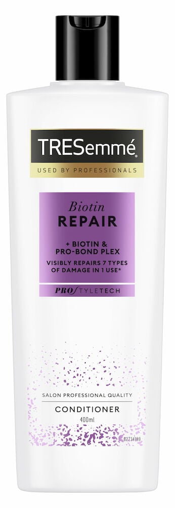 Vit plastflaska Tresemmé balsam med svart lock.