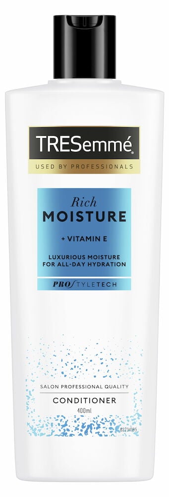 Vit balsamflaska med svart lock och blå etikett.