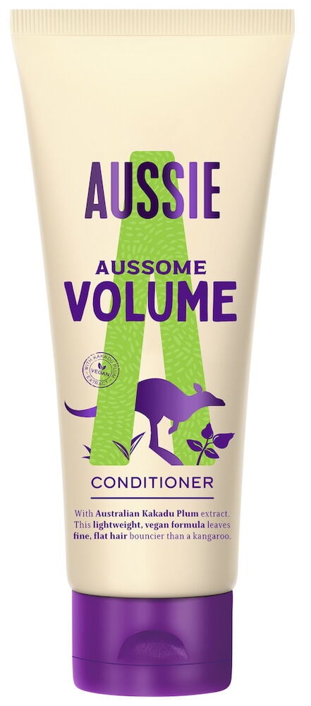 Plastflaska med lila lock och färgglad balsametikett.