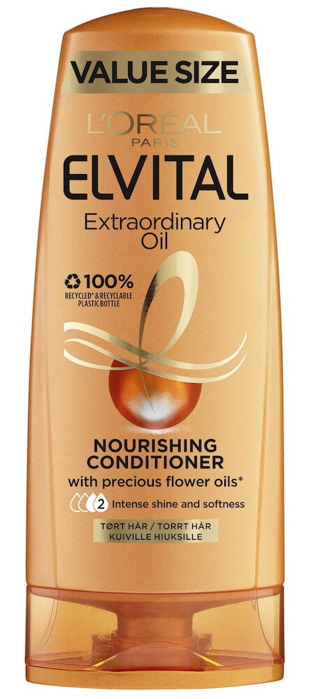 Orange balsamflaska med svart text och guldiga detaljer.