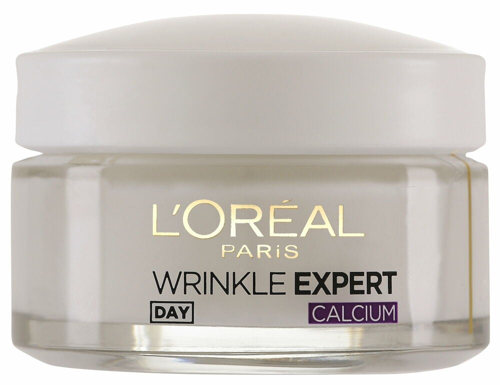 Genomskinlig burk med vit kräm och rund lock.