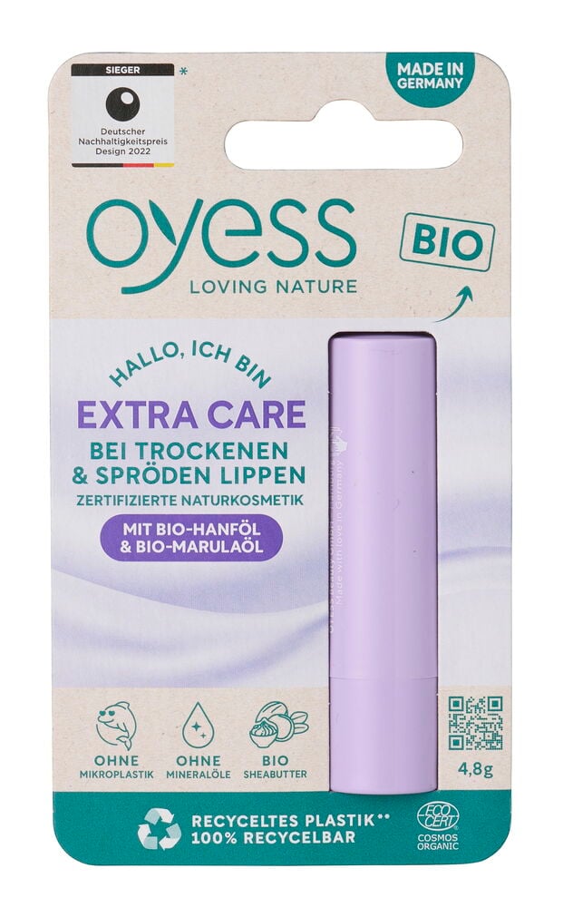 Lippenbalsam Oyess 4,8 g Extra Care in lila Tube in weißer und grüner Kartonverpackung, Vorderansicht.
