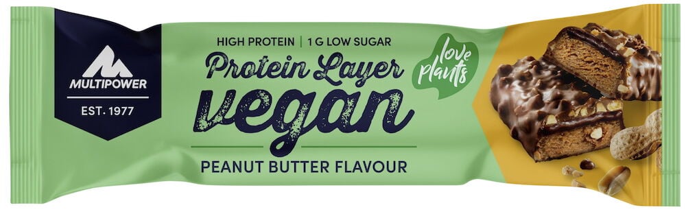 Ein hellgrün verpackter Proteinriegel Vegan Layer 55g Peanut Butter, zeigt zwei geschnittene Riegel mit Schokolade und Erdnüssen.