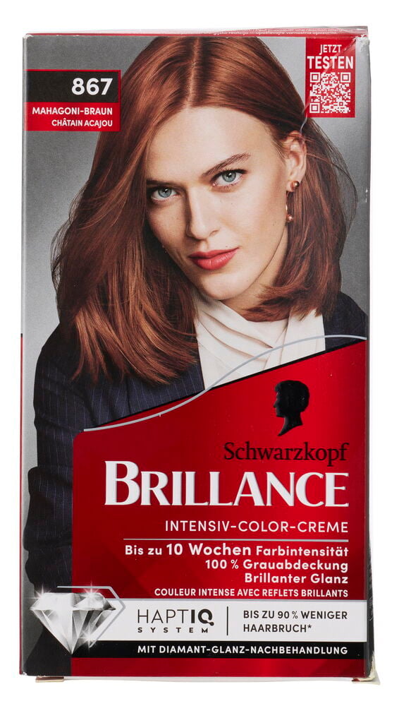 Haarfarbe Schwarzkopf Brillance 867 Mahagoni Braun Packung, Frau mit mahagonibraunem Haar, weißem Hemd und dunklem Blazer.