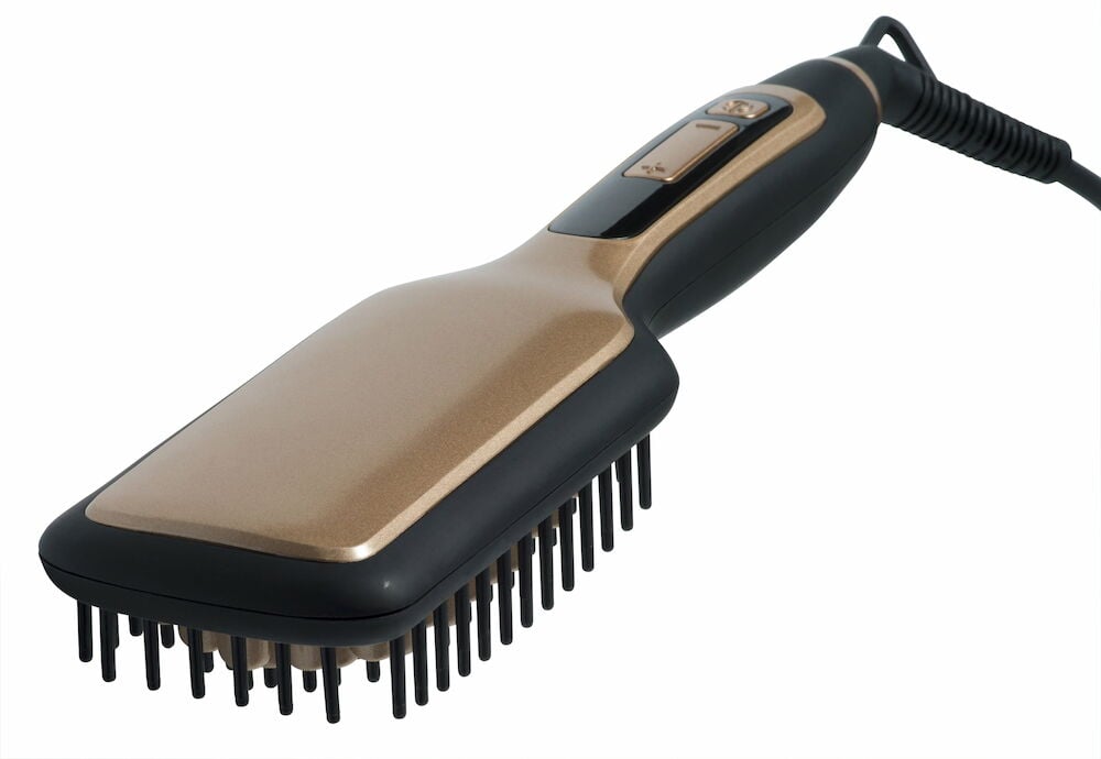 En paddle brush med svart og gull fargedesign.