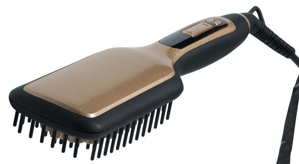 Flatbørste med svart og gull farge samt ledning.