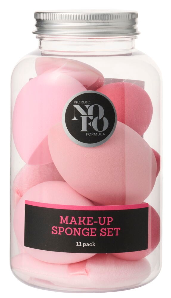 Ein klares Glas gefüllt mit rosa, verschiedenen NoFo Kosmetikschwämmen, beschriftet "MAKE-UP SPONGE SET 11 pack" auf einem schwarzen Etikett.