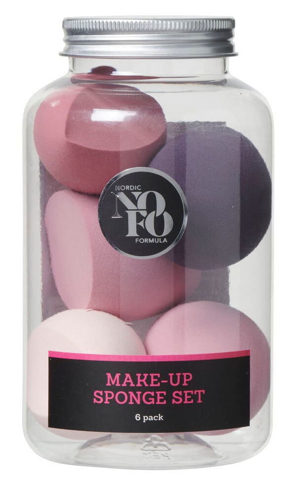 Sechs Schminkschwämme in verschiedenen Farben in einem Behälter.