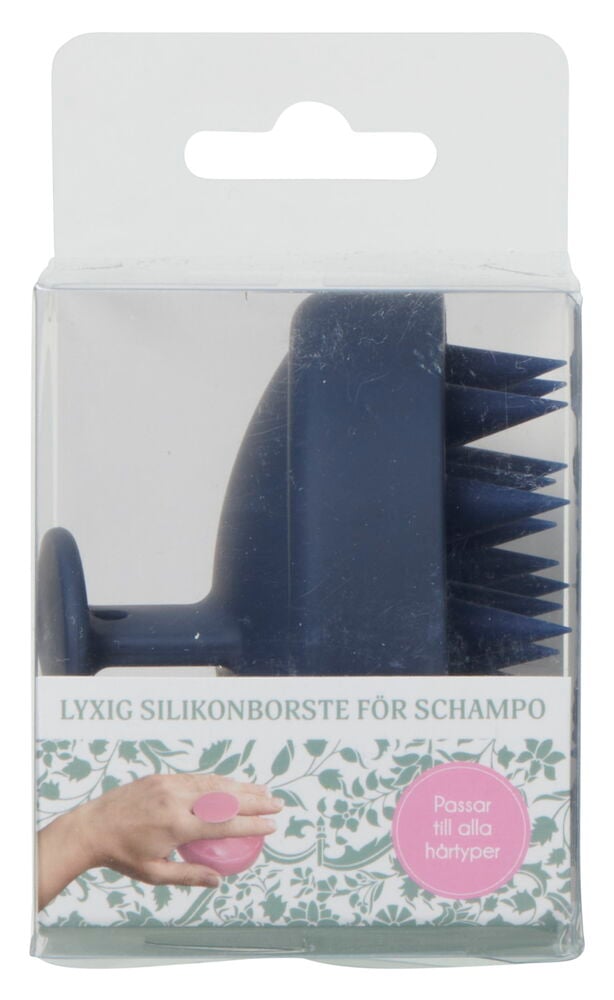 Blå schampoborste i silikon i genomskinlig förpackning.