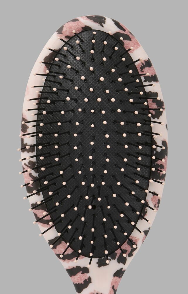 Haarbürste Trend, eine ovale rosa, schwarz-weiße Leopardenmuster-Bürste mit rosa-gespitzen schwarzen Borsten.