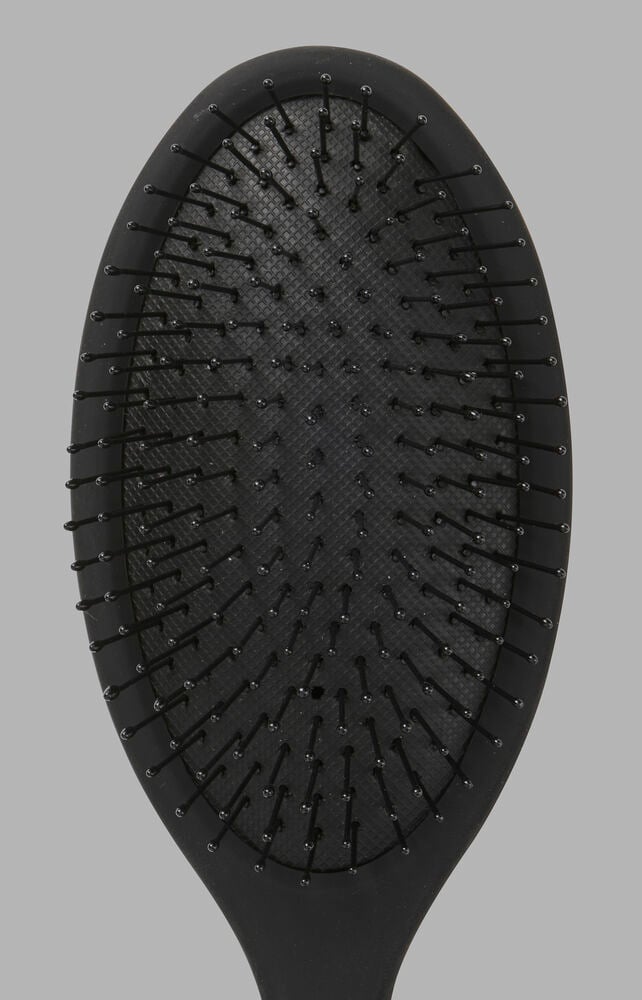 Schwarze ovale Haarbürste Trend mit strukturierter Polsterung und schwarzen Borsten mit kleinen Kugelspitzen.