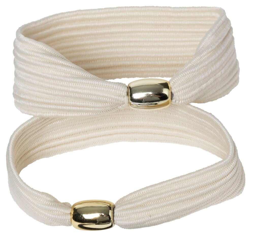 Två vita hårsnoddar med guldfärgade detaljer.