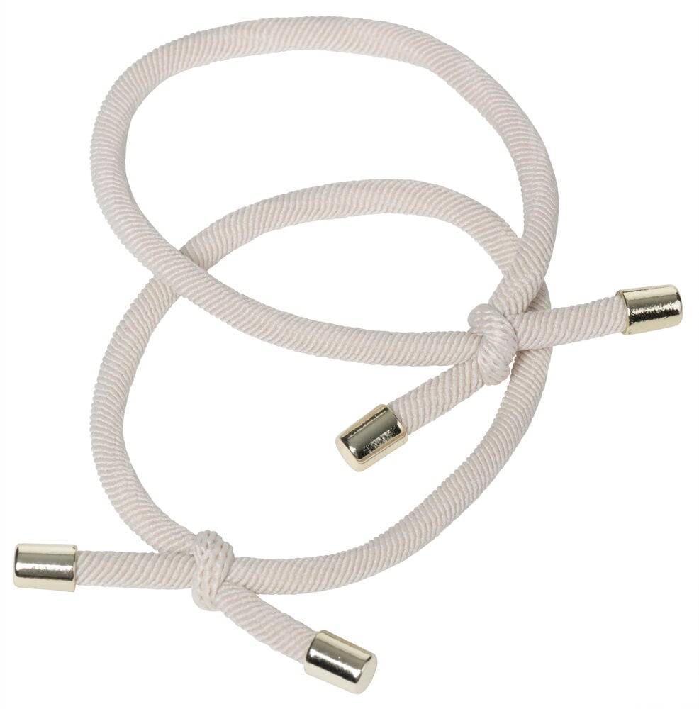 Två beige hårsnoddar med metalländar.