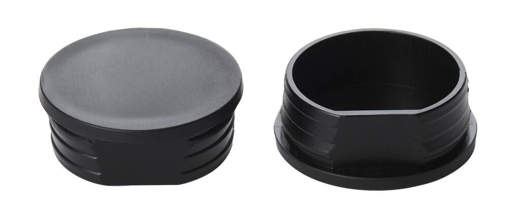 Två svarta reservdel täcklock multihållare till överliggare, visade uppifrån och inifrån.