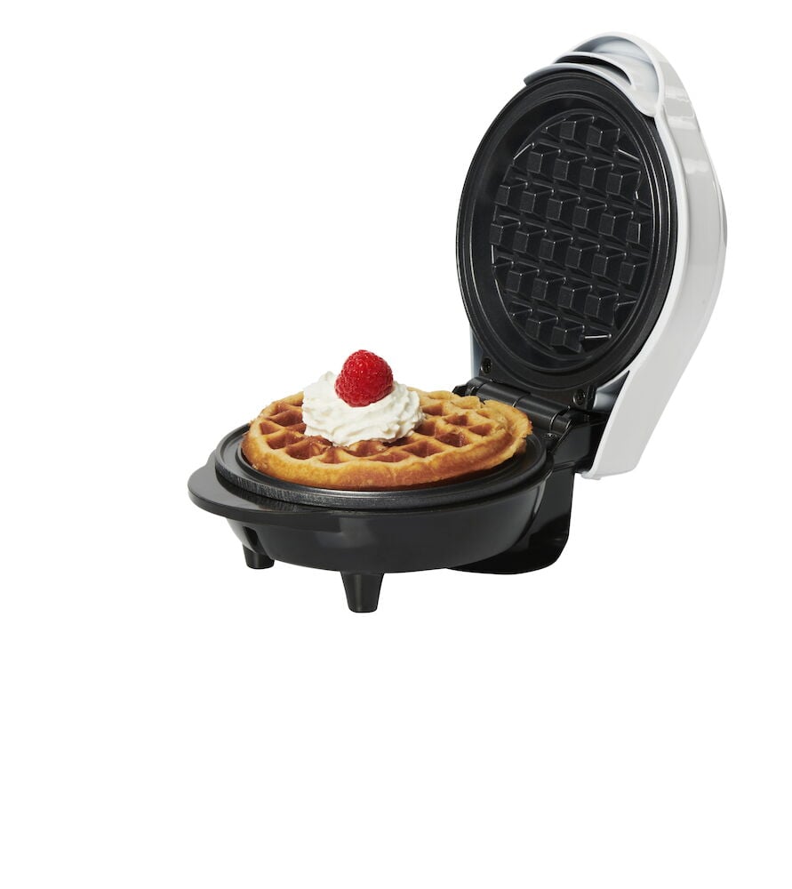 Öppet våffeljärn med belgisk våffla och grädde.
