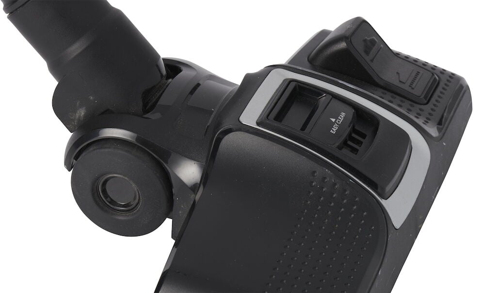 Svart dammsugarhuvud med hjul och justeringsknappar.