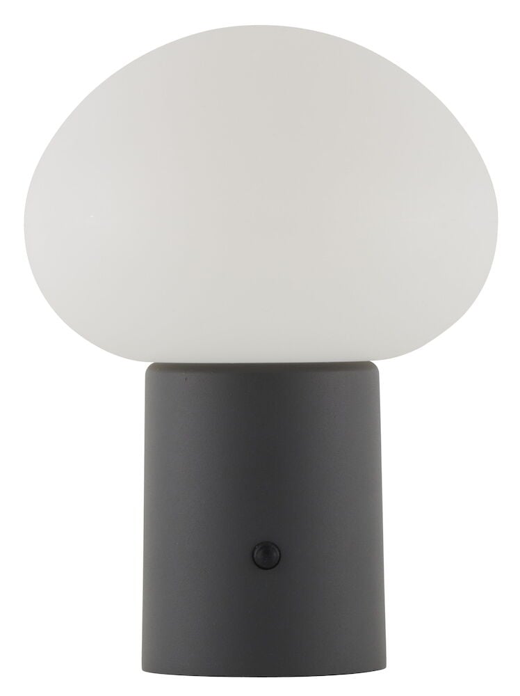 Valkoinen pöytälamppu mustalla sylinterin muotoisella jalalla.