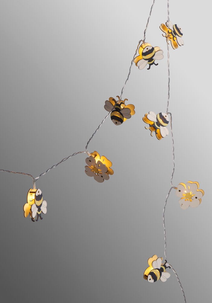 Ljusslinga med bin och blommor i pappersdesign.