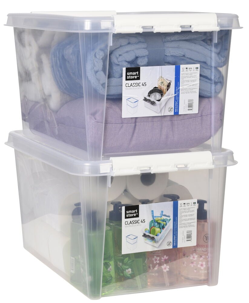 Två staplade genomskinliga förvaringslådor med vita lock.