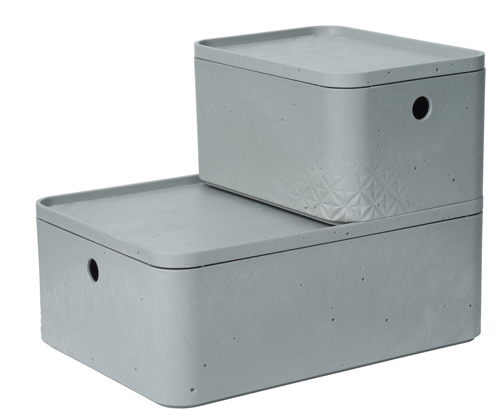 Två grå stapelbara förvaringslådor med runda hål.