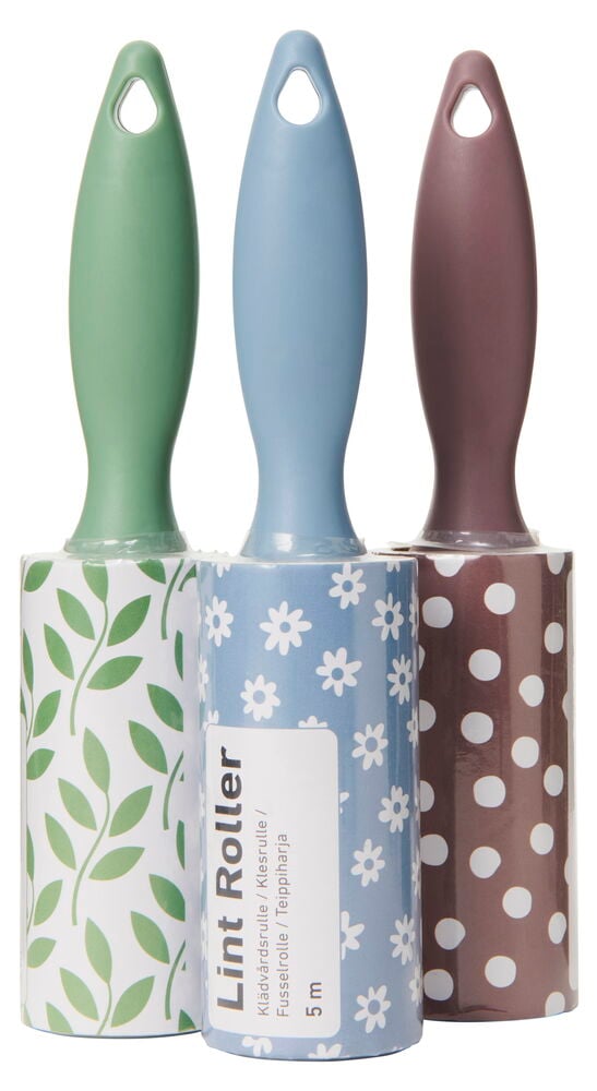 Tre klädvårdsrullar med mönstrade handtag och papper.