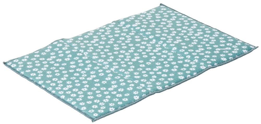 Rektangulärt turkost diskunderlägg med vita blommor.