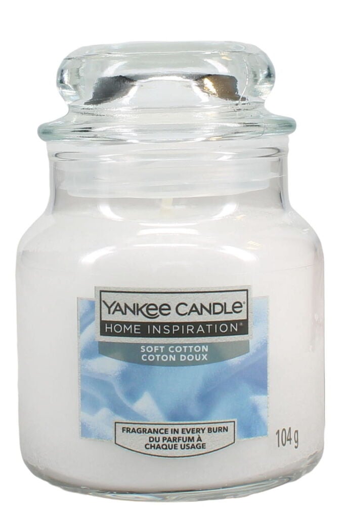 Weißes Duftkerze im Glasgefäß mit transparentem Deckel.