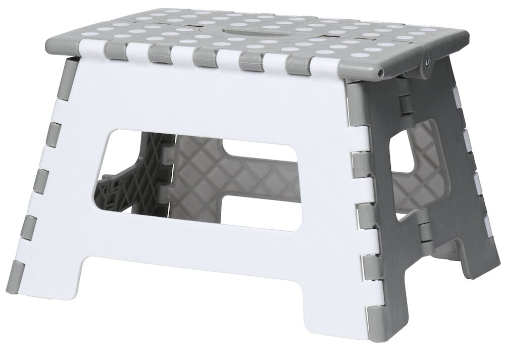 Hopfällbar svart pall med vita prickar.