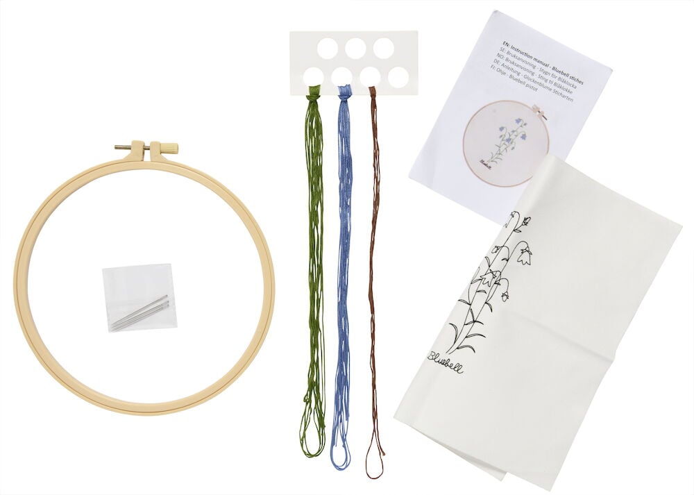 Broderikit med båge, garn, nålar och instruktioner.