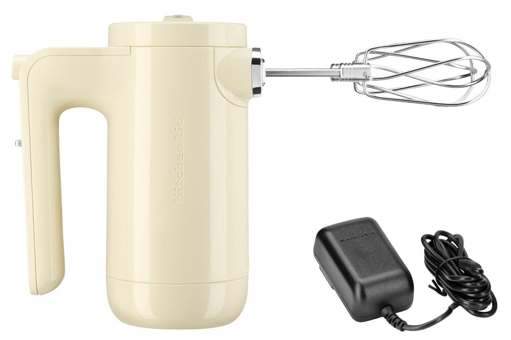 Ledningsfri kremhvit elektrisk visp med visper og lader.