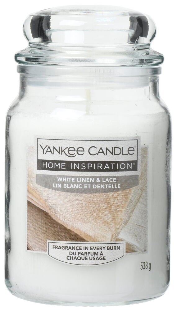 Stor glasskrukke med hvit duftlys og glasslokk.