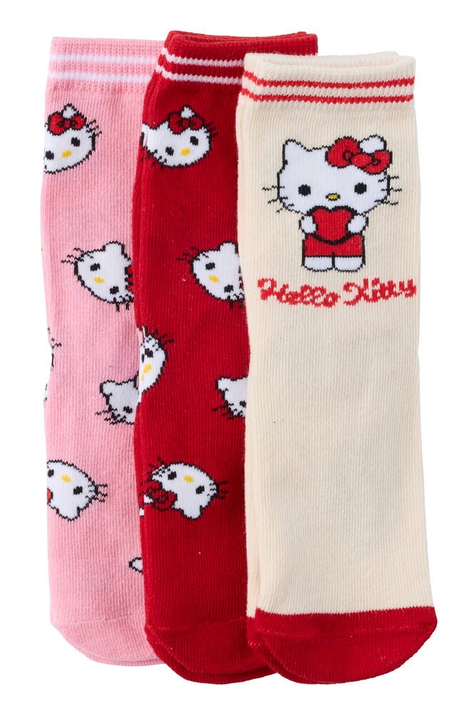 Ein 3er-Pack Kinderstrümpfe umfasst einen cremefarbenen Strumpf mit Hello Kitty, einen roten und einen rosa Strumpf.