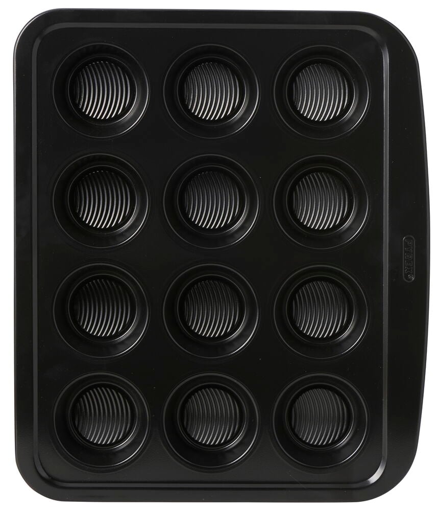 En svart Pyrex 34x40 cm Muffins- og cupcakeform med 12 bølge-mønstrede former, sett ovenfra.