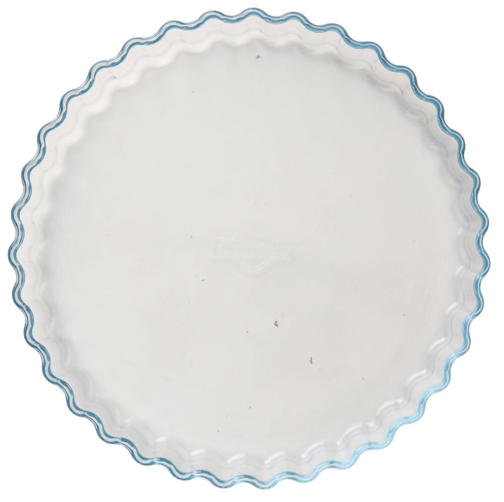 Eine runde, klare Glas Pieform Ô Cuisine Ø27 cm mit gewelltem Rand.