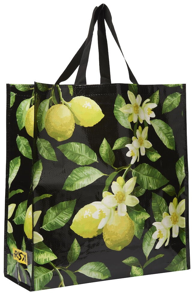 Handlepose Large Spring med svart bakgrunn, gule sitroner, hvite blomster og grønne blader.