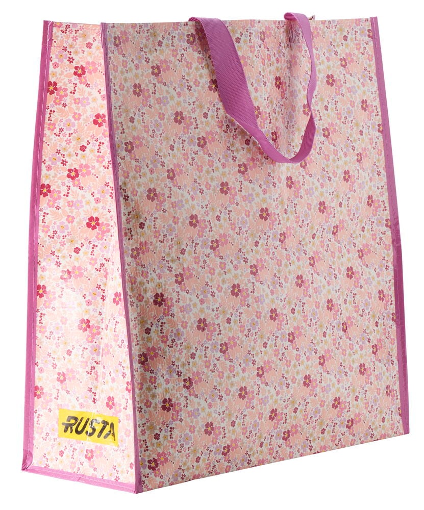 En stor Handlepose Large Spring med rosa blomstermønster og magentafargede håndtak.