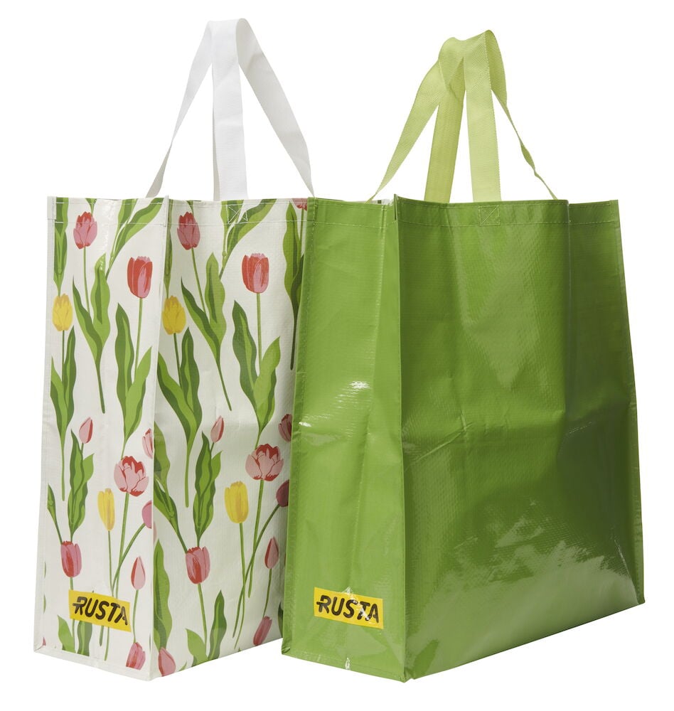 Hvit Handlepose Large Spring med rosa gule tulipaner, hvite håndtak, samt en grønn handlepose med grønne håndtak.