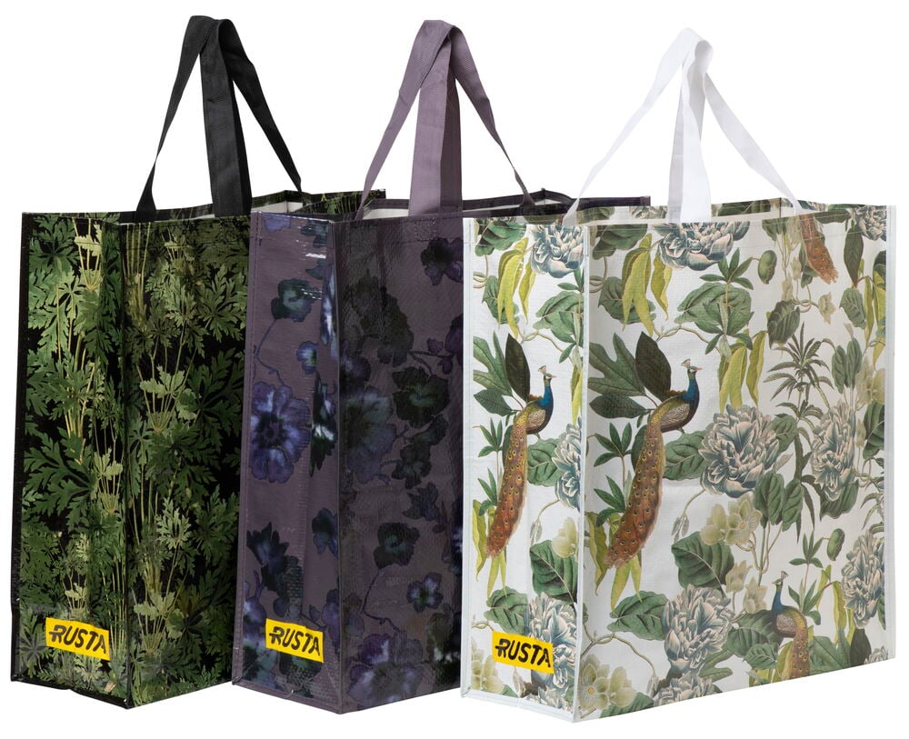 Tre stora shoppingkassar med olika färgglada mönster.